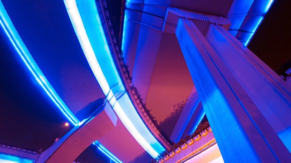 Stacks of highway  with purple white lights view from below at night