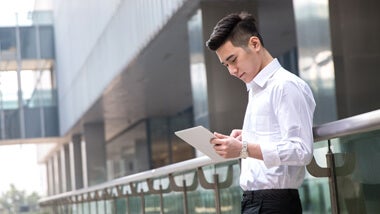 Asian man using electronic tablet